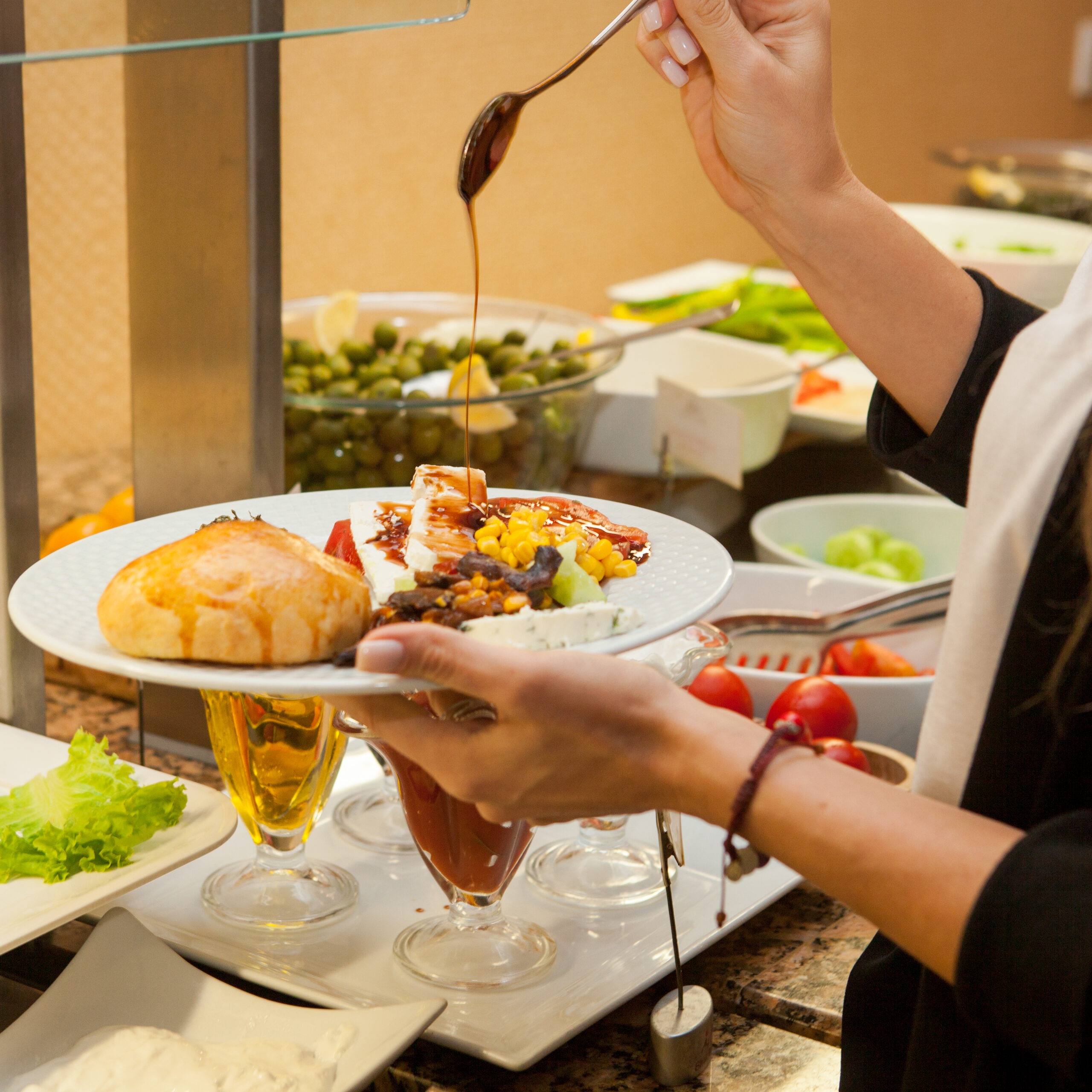 Woman preparing delicious meal in a kitchen . side view.